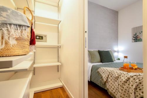a small bedroom with a bed and a closet at CASA ANTO - Charming apartment 50 meters from the beach in Alghero