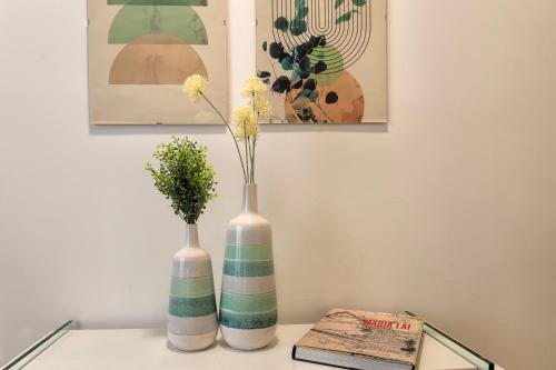 two vases sitting on top of a table at CASA ANTO - Charming apartment 50 meters from the beach in Alghero