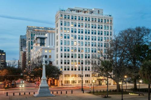 a tall white building with a statue in front of it at Moxy Columbia Downtown in Columbia