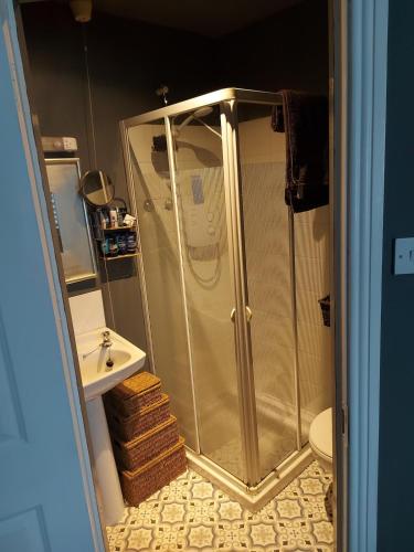 a bathroom with a shower and a sink at country break away in Gorey