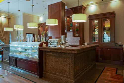 a restaurant with a counter with a display of food at Sheraton Dammam Hotel & Convention Centre in Dammam