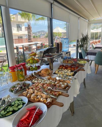 a long table with a buffet of food on it at Blue Water Hotel Ksamil in Ksamil