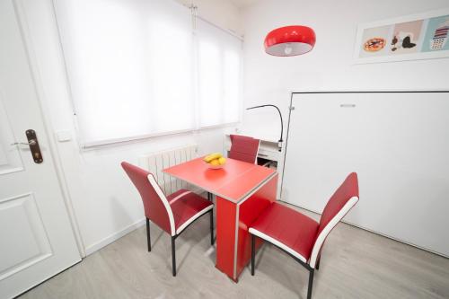 a red table and chairs in a room at En Madrid, amplio, especial grupos o familias in Leganés