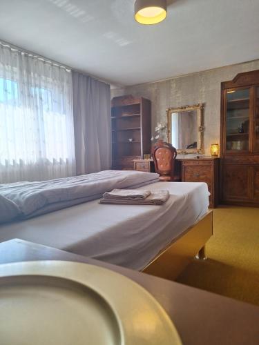 a bedroom with two beds and a sink and a mirror at Darmstadt Living in Darmstadt