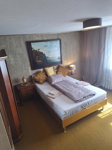 a bedroom with a bed with a painting on the wall at Darmstadt Living in Darmstadt