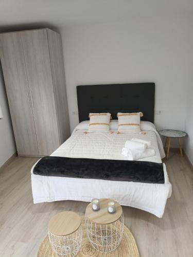 a bedroom with a large bed with two tables at Él Rincón de los Sueños A in Vegadecabo