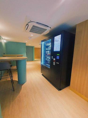 an empty office with a vending machine in a room at Myhotel Cmyk@Ratchada in Bangkok
