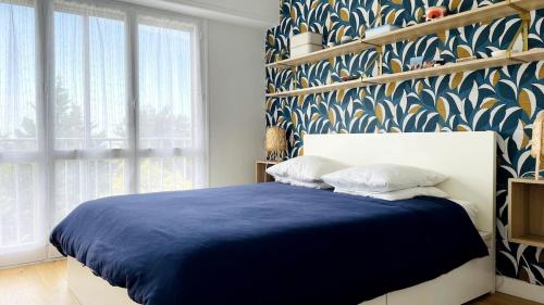 - une chambre avec un lit bleu et une couverture bleue dans l'établissement Appartement 3 chambres, très lumineux, plages et centre ville à pied, à Biarritz