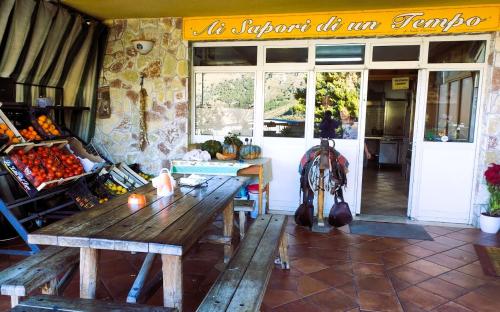 a store with a wooden table in front of a store at Sweet Home Pioppo in Pioppo
