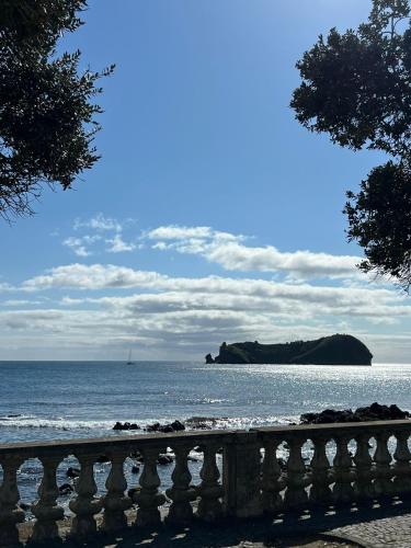 a view of the ocean with a boat in the distance at Esplanada do Ilhéu in Vila Franca do Campo