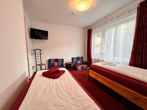 a bedroom with two beds and a window at W.I.P. Welt im Park in Dresden