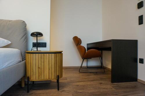 a bedroom with a bed and a desk and a chair at MT Suites ApartHotel in Budapest