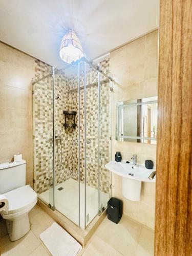 a bathroom with a shower and a toilet and a sink at Charmant Appartement 2 Room Wifi Marrakech in Marrakesh