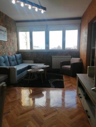 a living room with a couch and a table at TINAa in Kragujevac