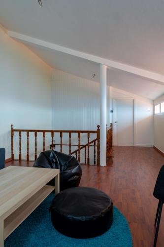 a living room with a bean bag chair and a table at Villa-Kasia Ocean View Studios in Caniço