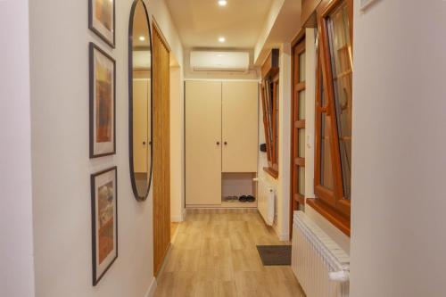 a hallway with white walls and wooden floors at Prestige Apartment & Studio Apartment in Ðakovo