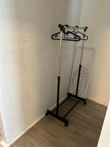 a black iron stand in the corner of a room at APARTMENT GAL in Novo Mesto