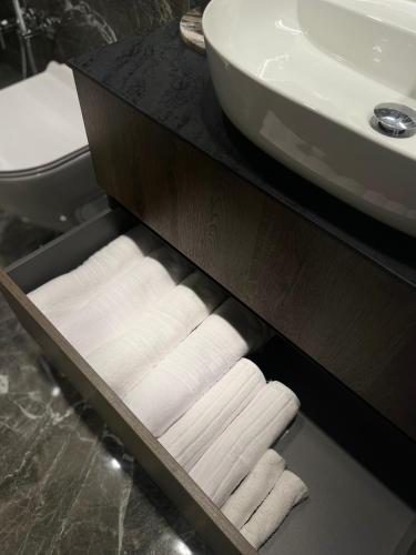a drawer with folded towels in a bathroom at Dune Suite - Palangos loftai in Palanga