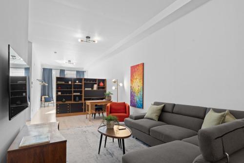a living room with a couch and a table at New Modern 2bdr Apartment in Little Italy in Montréal