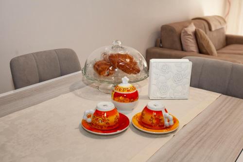 a table with two tea cups and a bowl of food at Case vacanze Taiji in Cassino