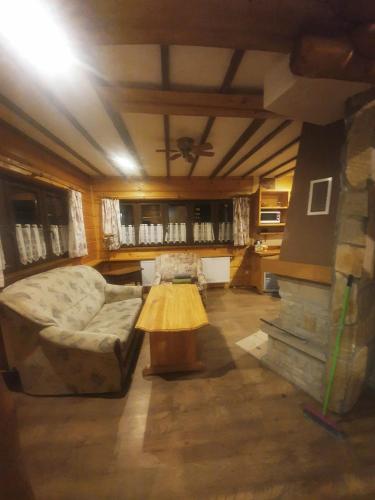 a living room with a couch and a table at Osada Załuż in Sanok