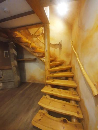 a set of wooden stairs in a room at Osada Załuż in Sanok
