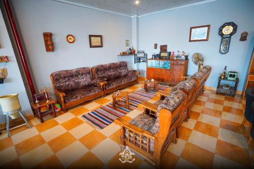 a living room with two couches and a table at Vote Hotel 2 in Erbil