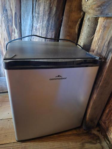 a metal cooler sitting on the floor next to a wall at Cabane insolite in Saint-Germain-de-Calberte