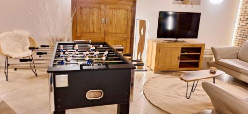 a living room with a foosball table at Gîte Havre forêt in Bouillon