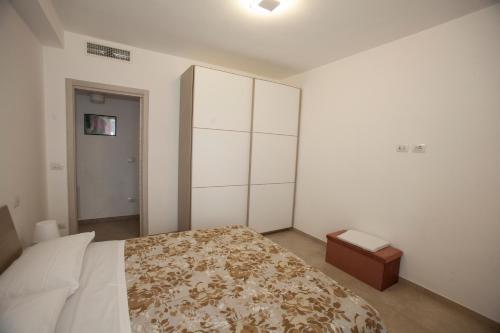 a bedroom with a large bed and a cabinet at Case vacanze Taiji in Cassino