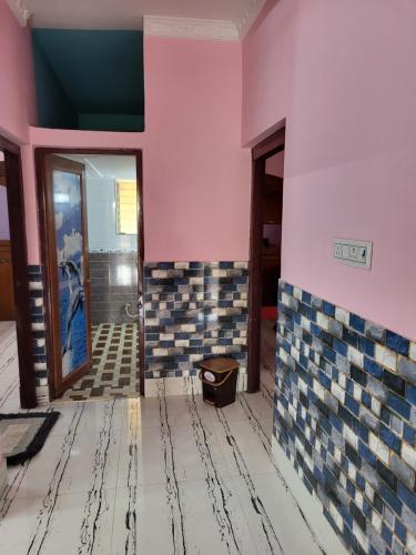 a bathroom being remodeled with pink and blue tile at Jamenas house in kolkata