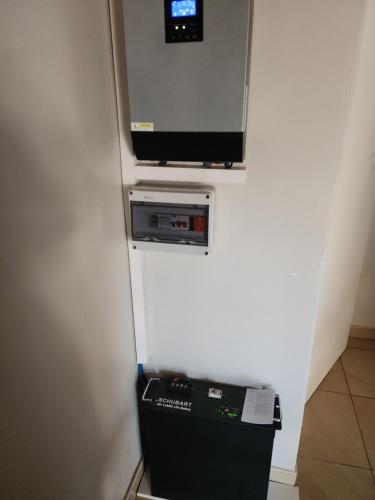 a room with a television and a small refrigerator at Eastern Road Executive Suites in Harare