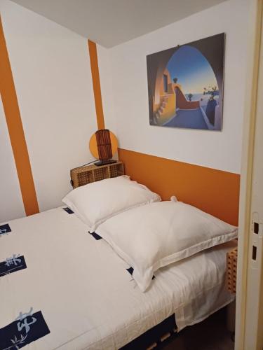 une chambre avec deux lits et un tableau au mur dans l'établissement Evasion à Meschers - Piscine - Plage - Tennis - Familles, à Meschers-sur-Gironde