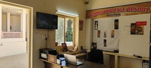 an office with a desk and a sign on the wall at Brahma Heritage-Pool with Nature in Pushkar