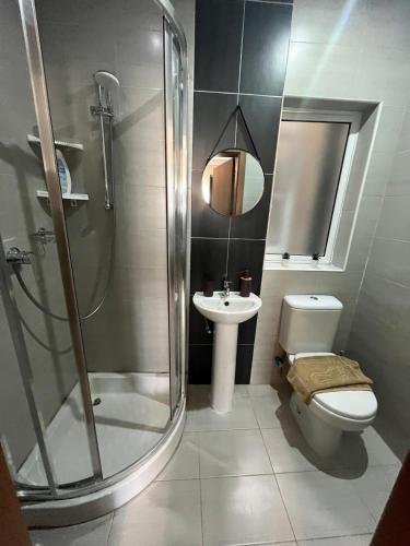 a bathroom with a shower and a toilet and a sink at Susannah's Place in Żejtun