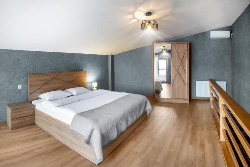 a bedroom with a large bed and a mirror at Terrace Akhaltsikhe in Akhaltsikhe