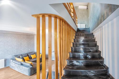 a staircase leading up to a living room with a couch at Terrace Akhaltsikhe in Akhaltsikhe