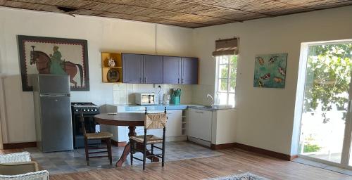a kitchen with a table and a counter top at Paisible oasis in Case Noyale