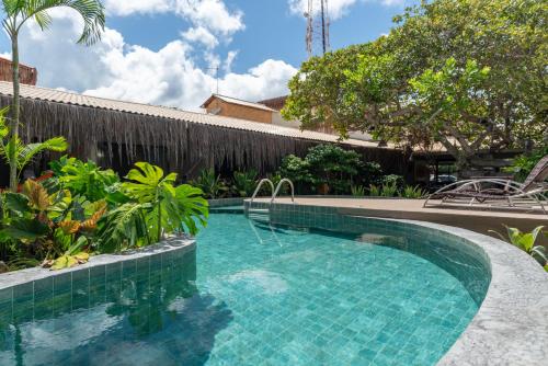 a swimming pool in front of a fence with a swimming pool at Pousada Sempre Graciosa in Praia do Frances