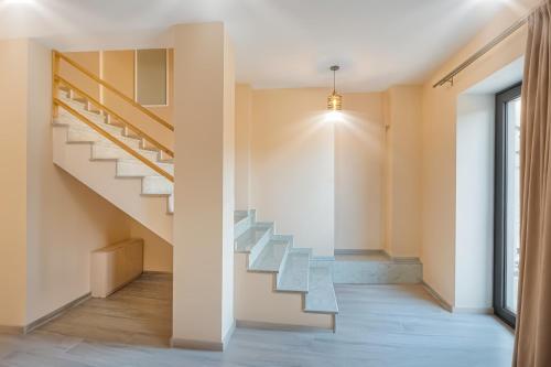 a staircase in a house with a glass railing at Terrace Akhaltsikhe in Akhaltsikhe