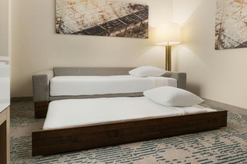 two twin beds in a room with a lamp at SpringHill Suites by Marriott Tampa Westshore in Tampa