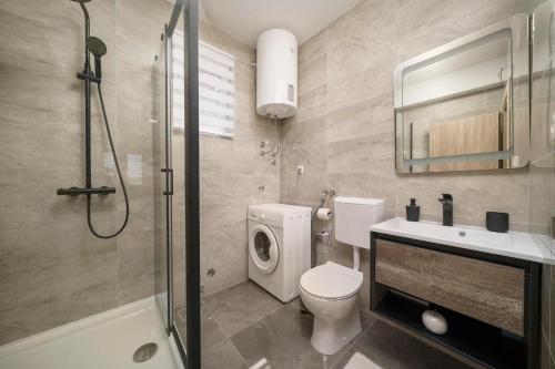 a bathroom with a toilet and a sink and a shower at Carpe Diem in Raslina