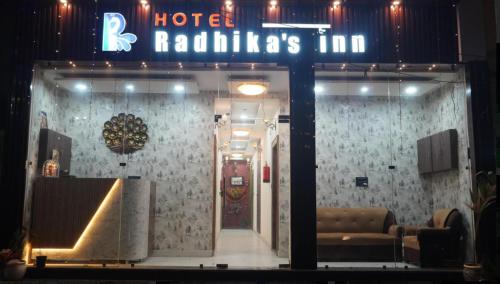 a store window with a hotel railillas inn sign at Hotel Radhika's Inn in Mathura