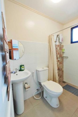 a bathroom with a toilet and a sink at Intoy's Place Panglao near Beach in Panglao