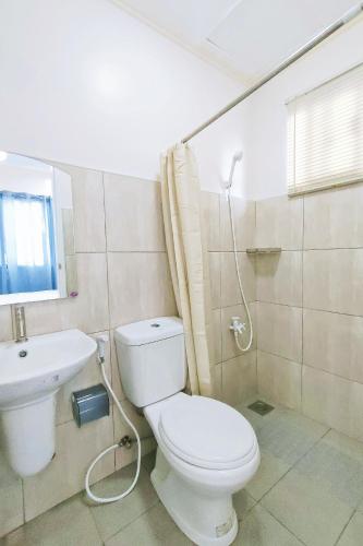 a bathroom with a toilet and a sink at Intoy's Place Panglao near Beach in Panglao