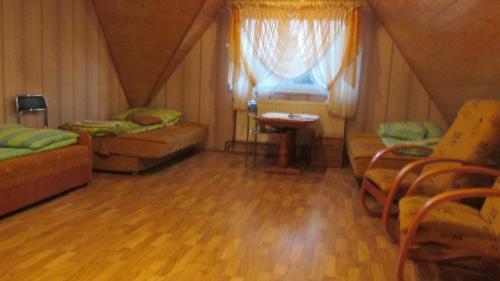 a room with a bed and a table and a window at Zajazd U Renaty in Poraj