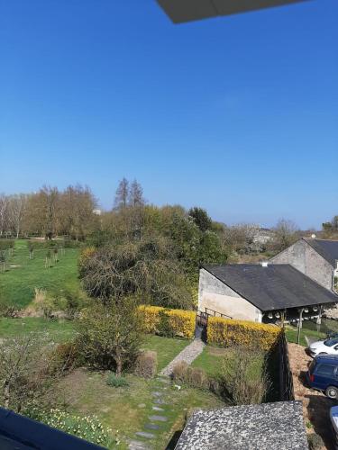 a view from the window of a house with a yard at Au pied du Lavoir Chambre Odile in Grézillé