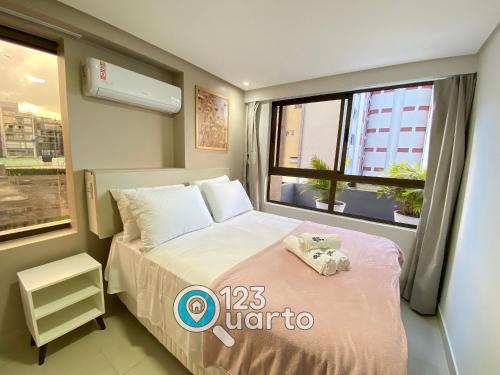 a small bedroom with a bed and a window at Gold Flat Cabo Branco By 123Quarto Hospedagem in Tambaú