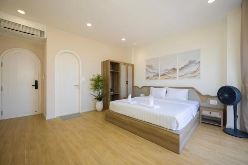 a bedroom with a large white bed in a room at Lotus Home Cafe - Cable Car Station in Phú Quốc