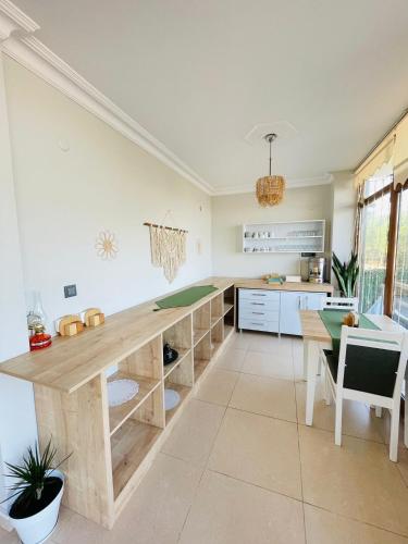 a kitchen with a wooden counter and a table at Ağva Manolyam Otel in Sile